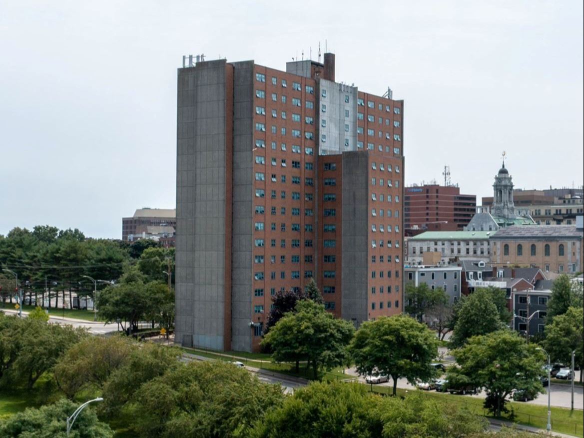 Drone photo of Franklin Towers High Rise from the East Bayside Neighborhood, surrounded by greenery